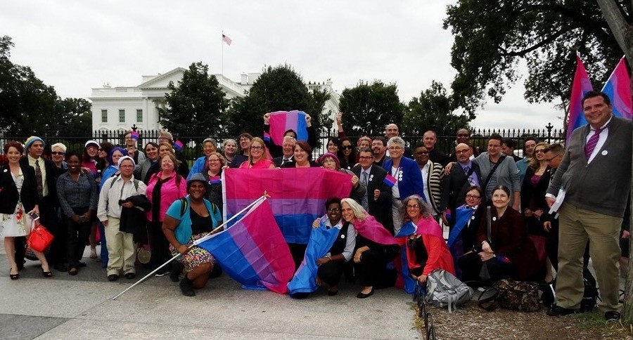 Larger group on White House Lawn with bisexual banners.